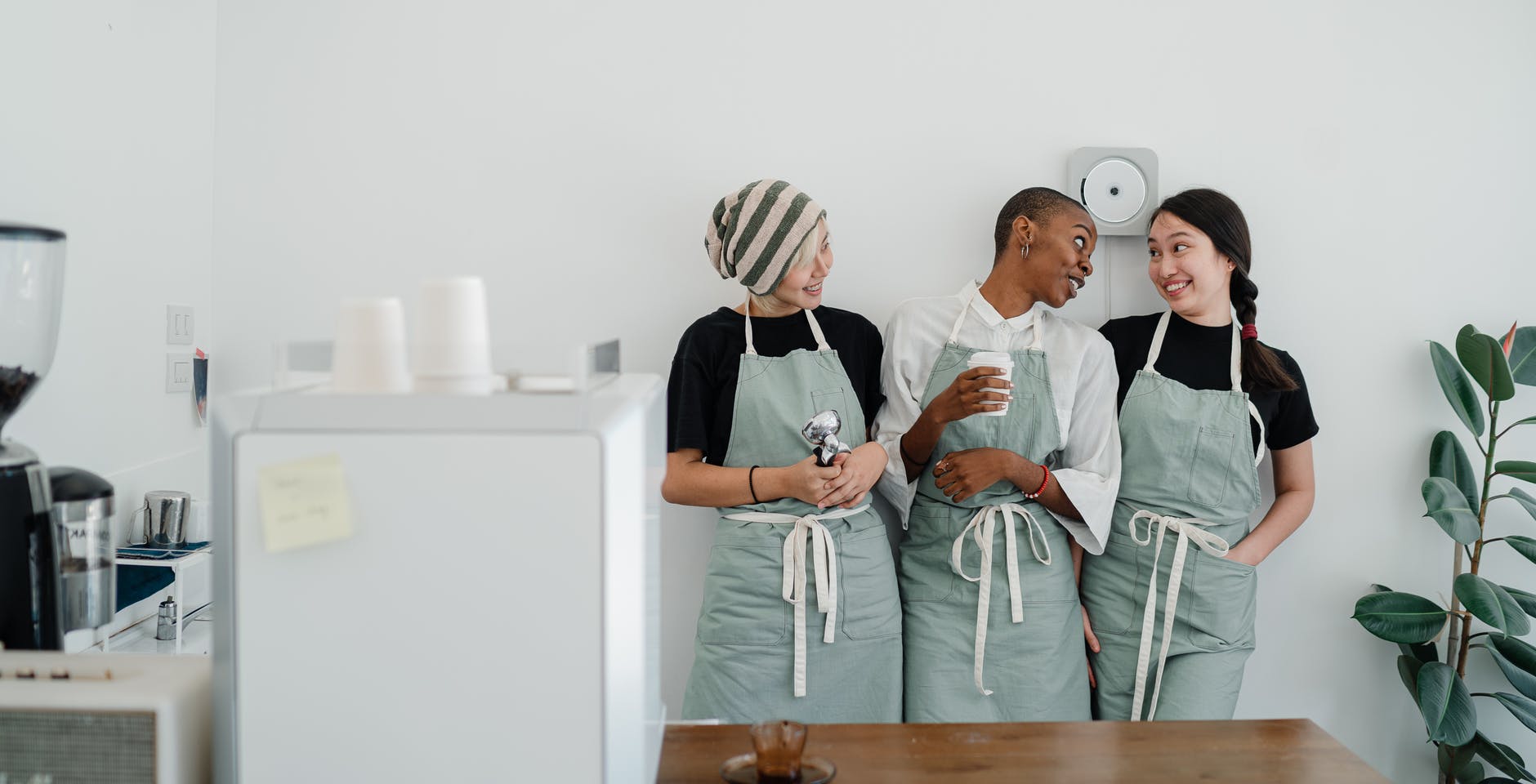 friendly young diverse waitresses communicating during work in cafe